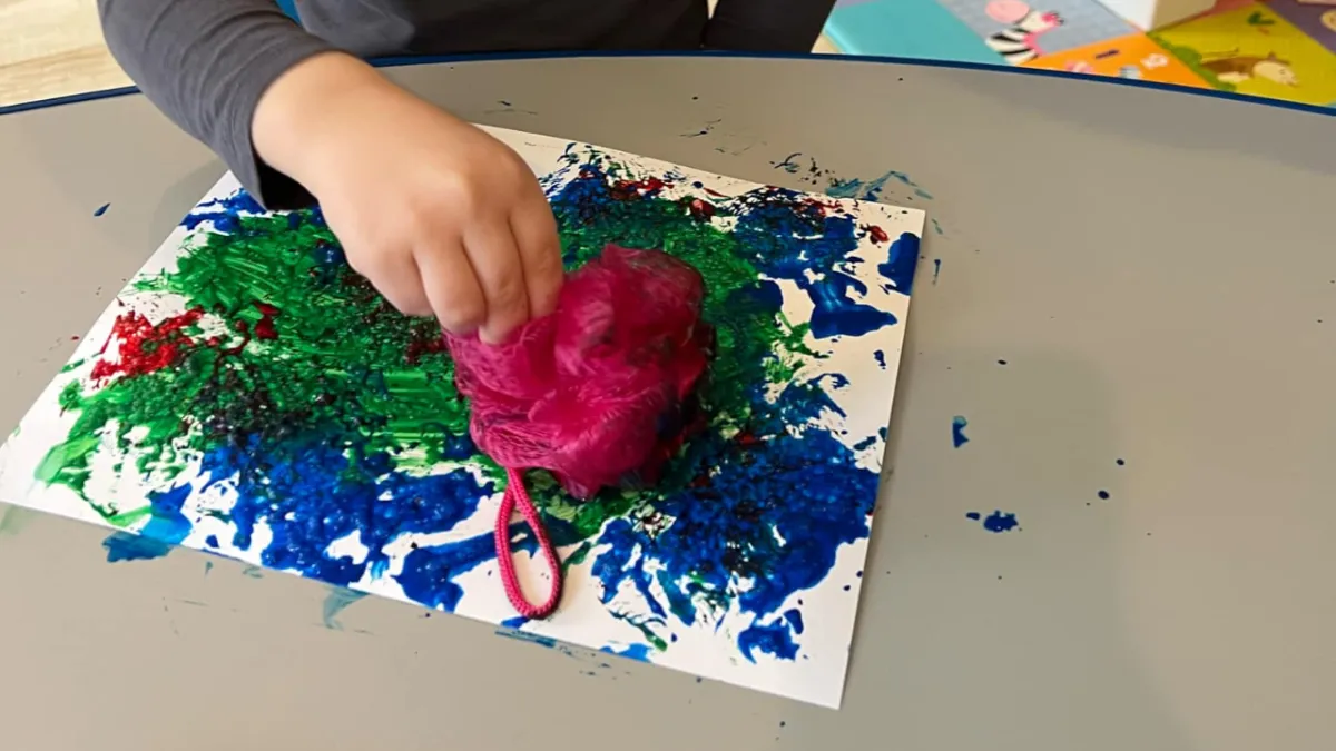 Girl follows directions during arts and crafts time.