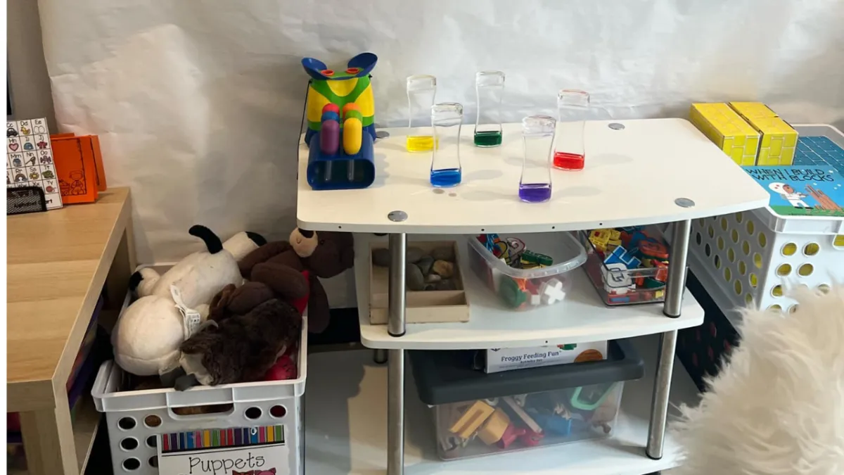 Boy picks paper out of different colored liquids