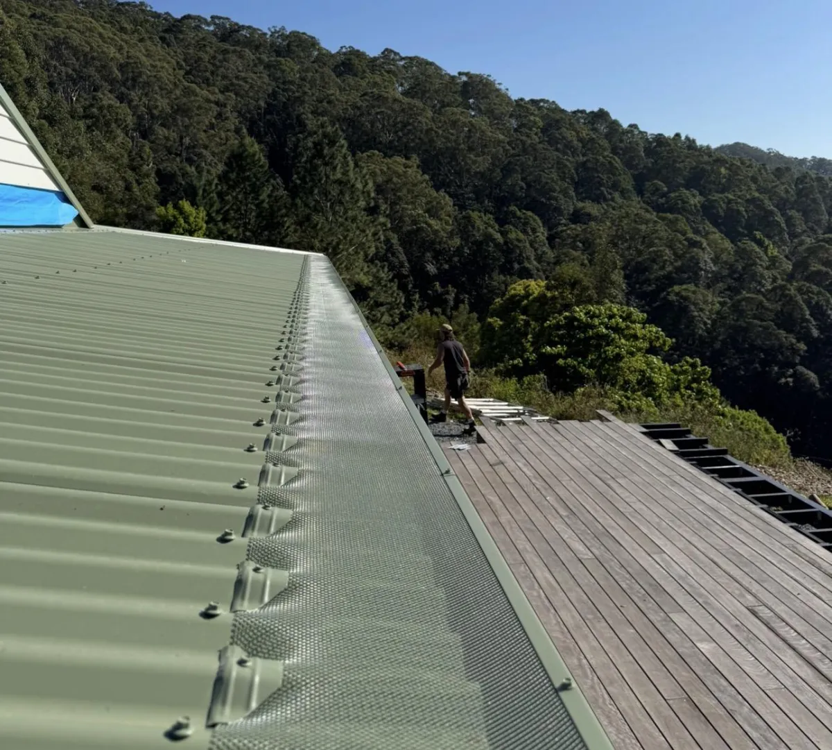 pale eucalypt gutter guard installed on corrugated roof