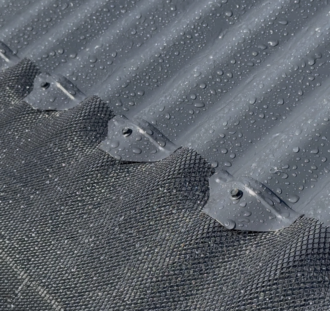 Corugated iron gutter guard installation close up