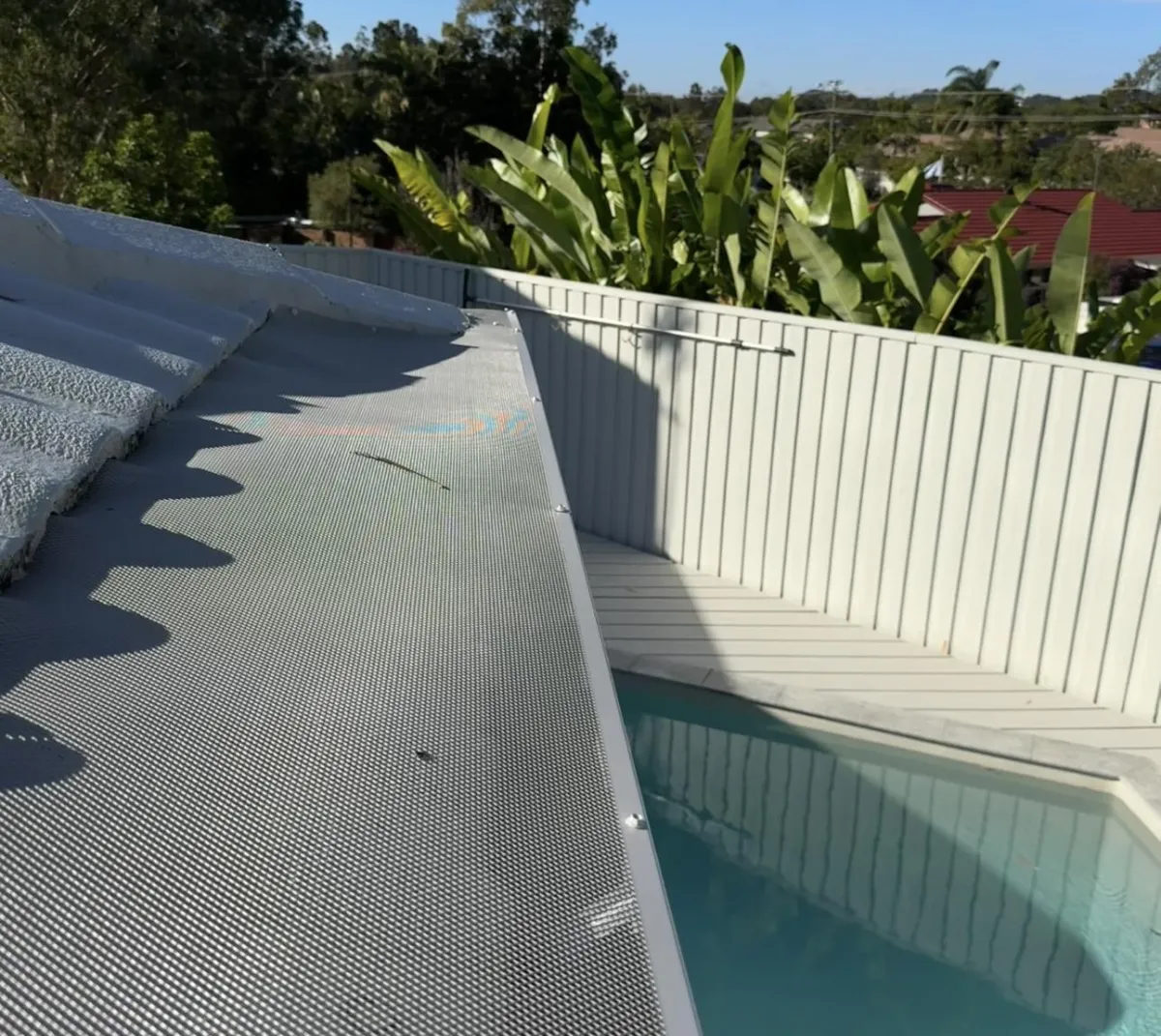 Tile gutter guards installed next to pool