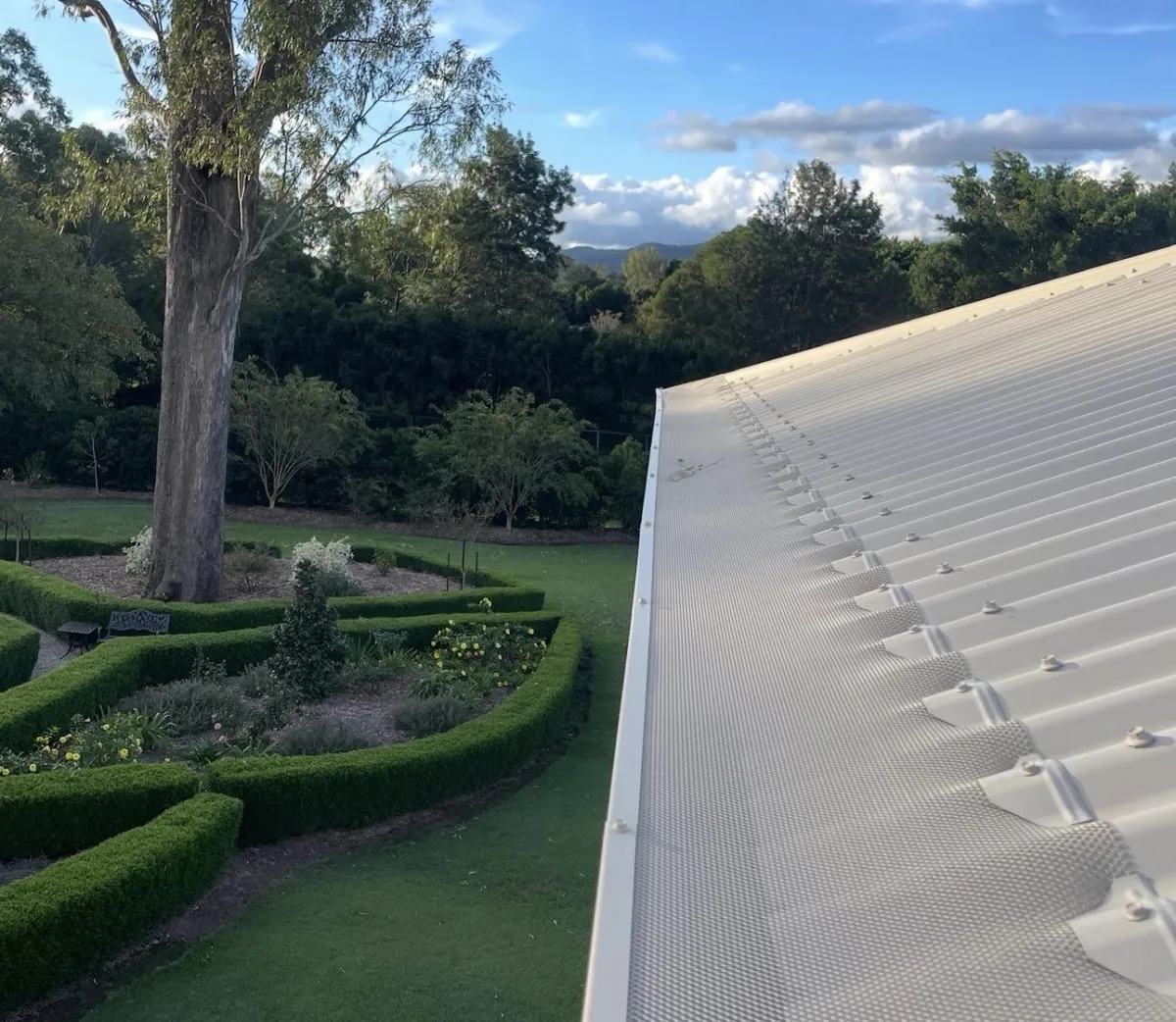 paperbark guttter guard installer on corrugated iron house