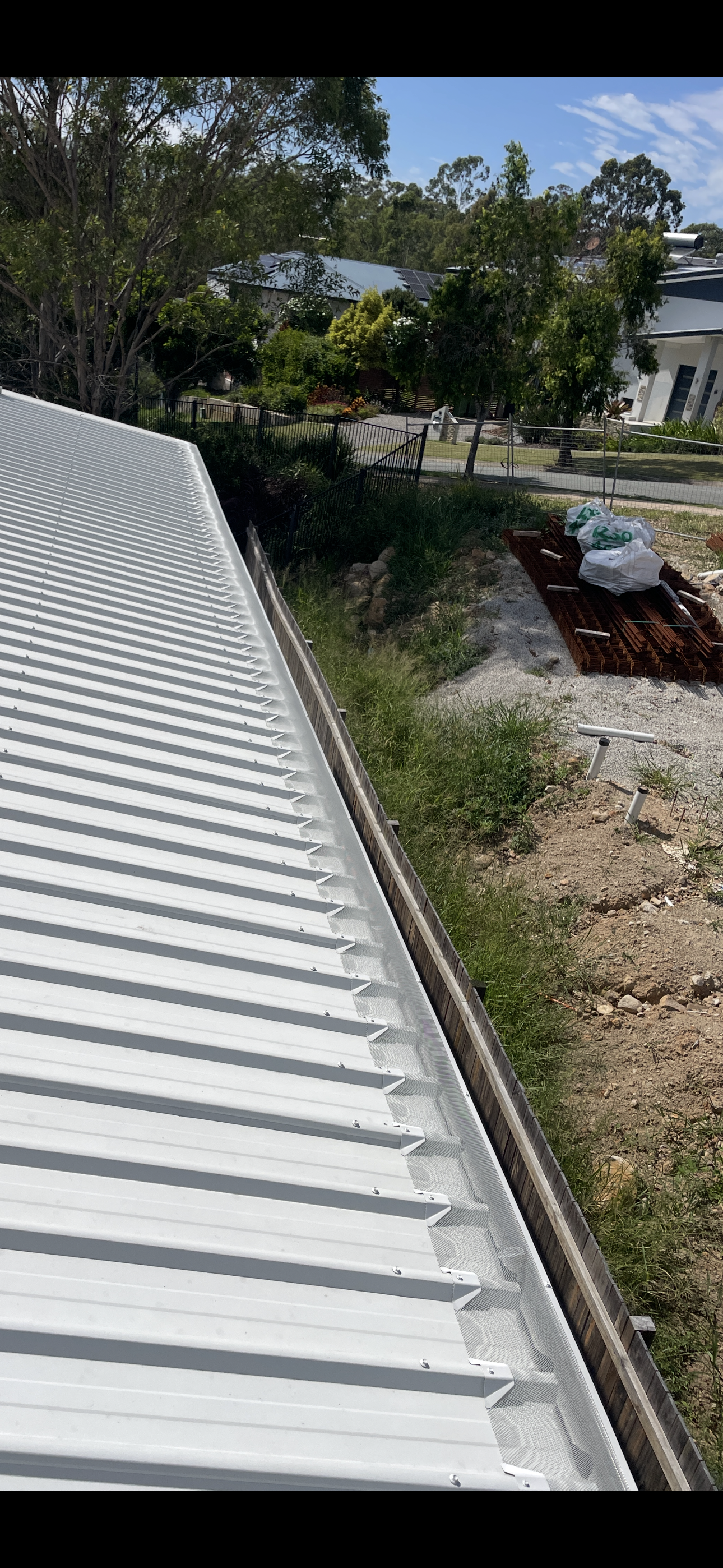 Corrugated roof with aluminium gutter guard installation in Australia
