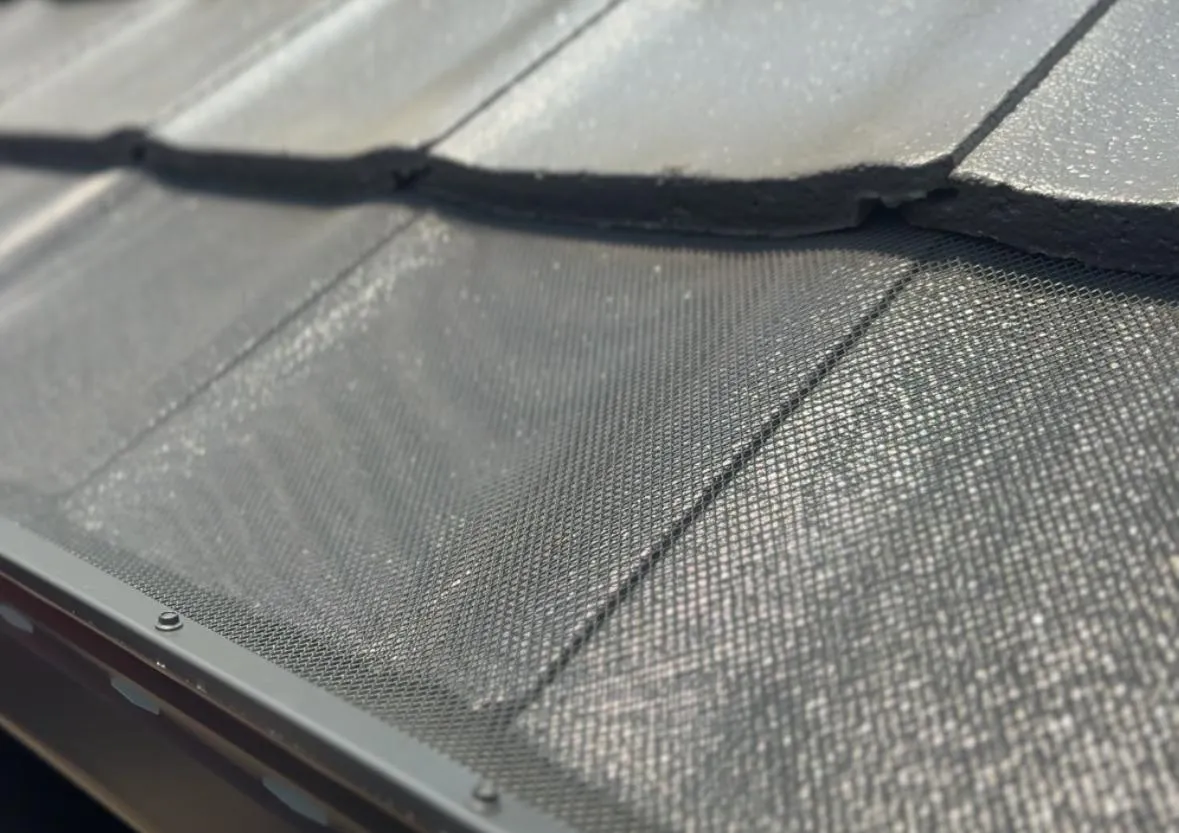 Tile roof gutter guard installation preventing leaf build-up and overflow
