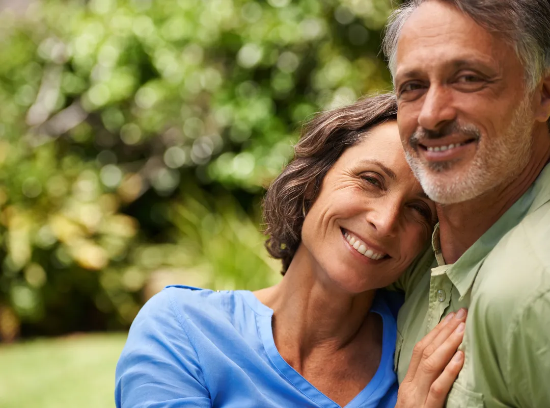 Older man and women hugging and smiling