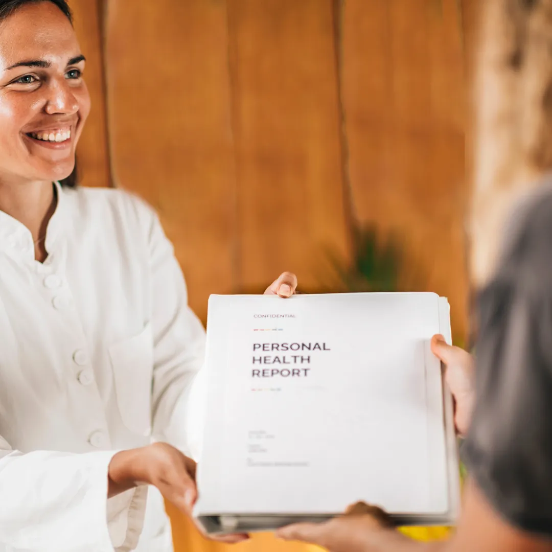 Women holding a personal health report booklet