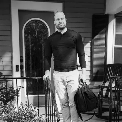 Brian Peerbolt, piano tuner, standing in front of a house in Grand Rapids, Michigan.