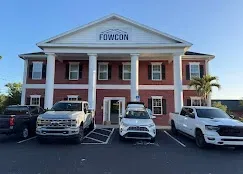 Modern home addition in Tampa featuring spacious living area, large windows, and elegant siding amidst lush landscaping.