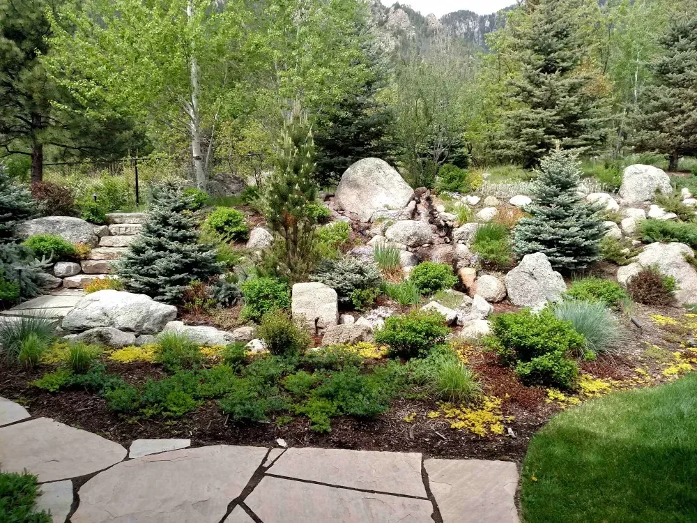 Commercial building bordered by colorful native perennials and river-rock mulch