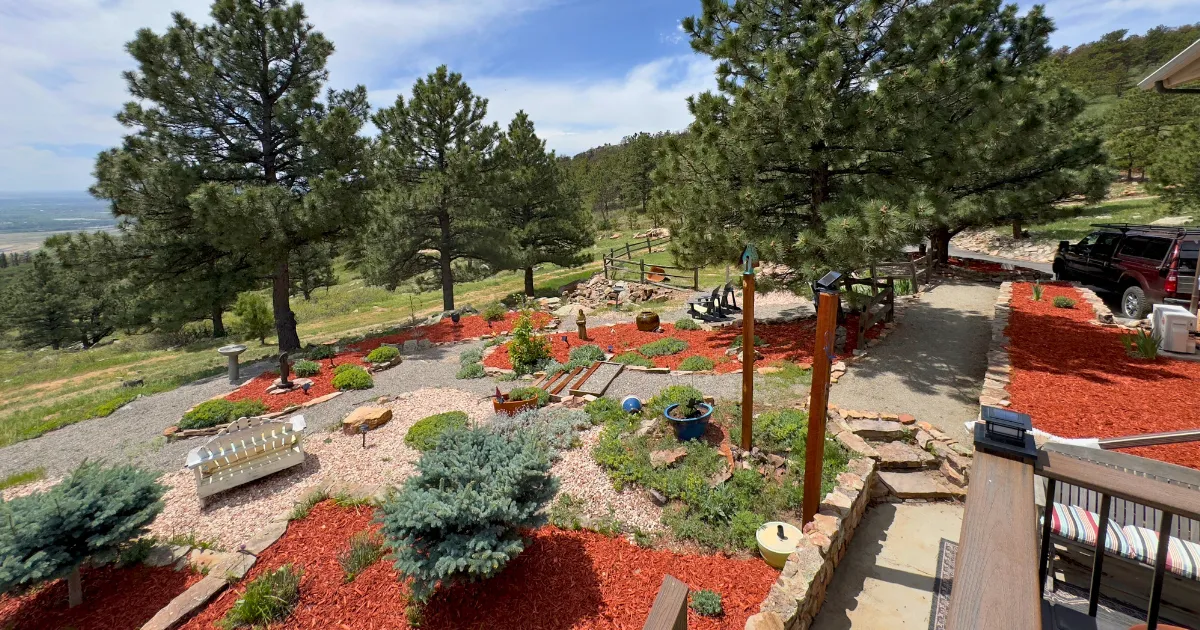 Boulder County paver walkway office entrance with neatly clipped shrubs and yellow daylilies