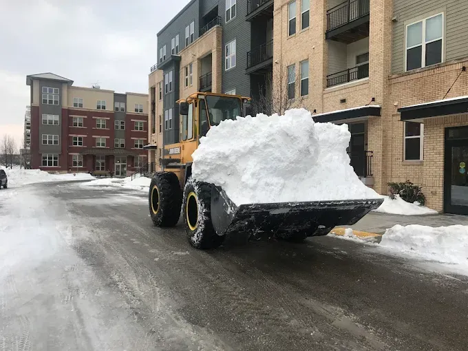 ASR Property Services wheel loader clearing snow at a commercial property in Wisconsin.
