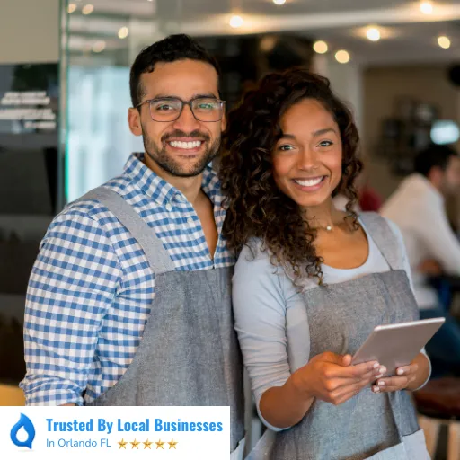 Happy Orlando business owners standing confidently in front of their thriving local business after partnering with Living Logos Media for digital marketing services