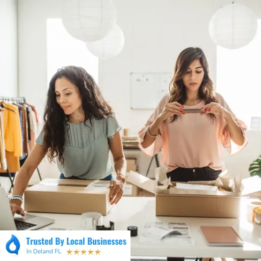 Happy Deland business owners working confidently in front of their thriving local business after partnering with Living Logos Media for digital marketing service