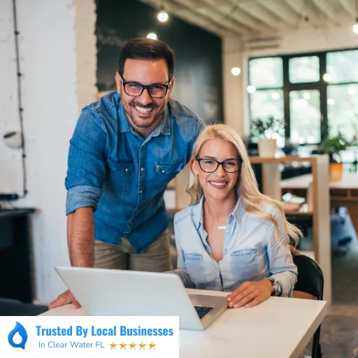 Happy Clearwater business owners sitting confidently inside of their thriving local business after partnering with Living Logos Media for digital marketing services