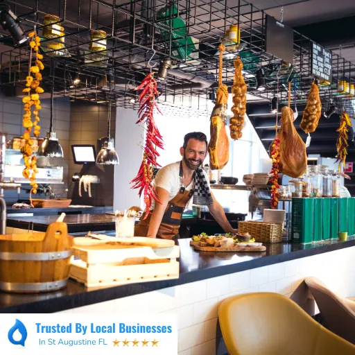 Happy St Augustine business owner standing confidently in front of their thriving local business after partnering with Living Logos Media for digital marketing services