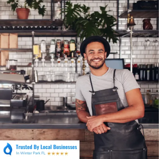 Happy Winter Park business owner standing confidently in front of their thriving local business after partnering with Living Logos Media for digital marketing services