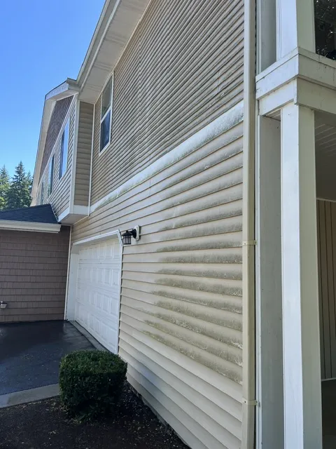 Freshly washed two-story home with cedar shingle siding and a clean covered porch in Olympia, WA