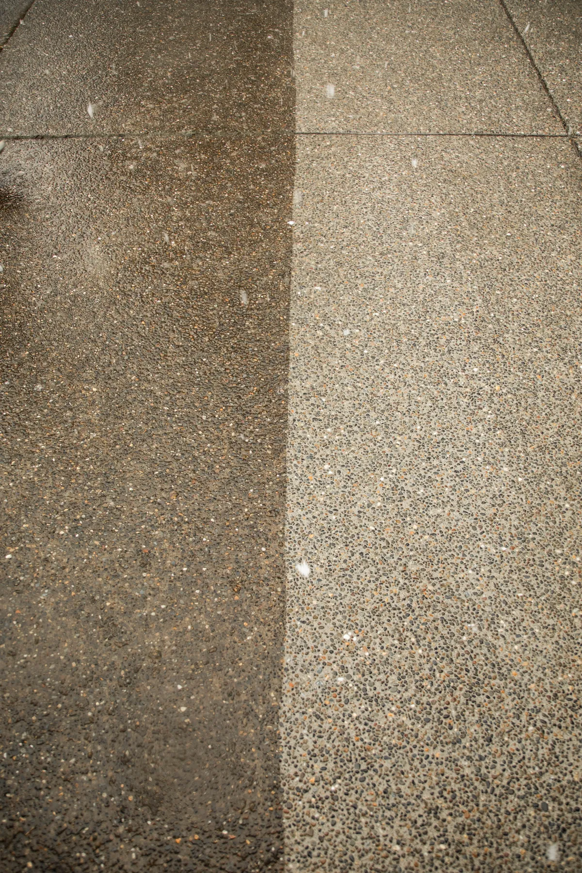 Concrete driveway being pressure-washed