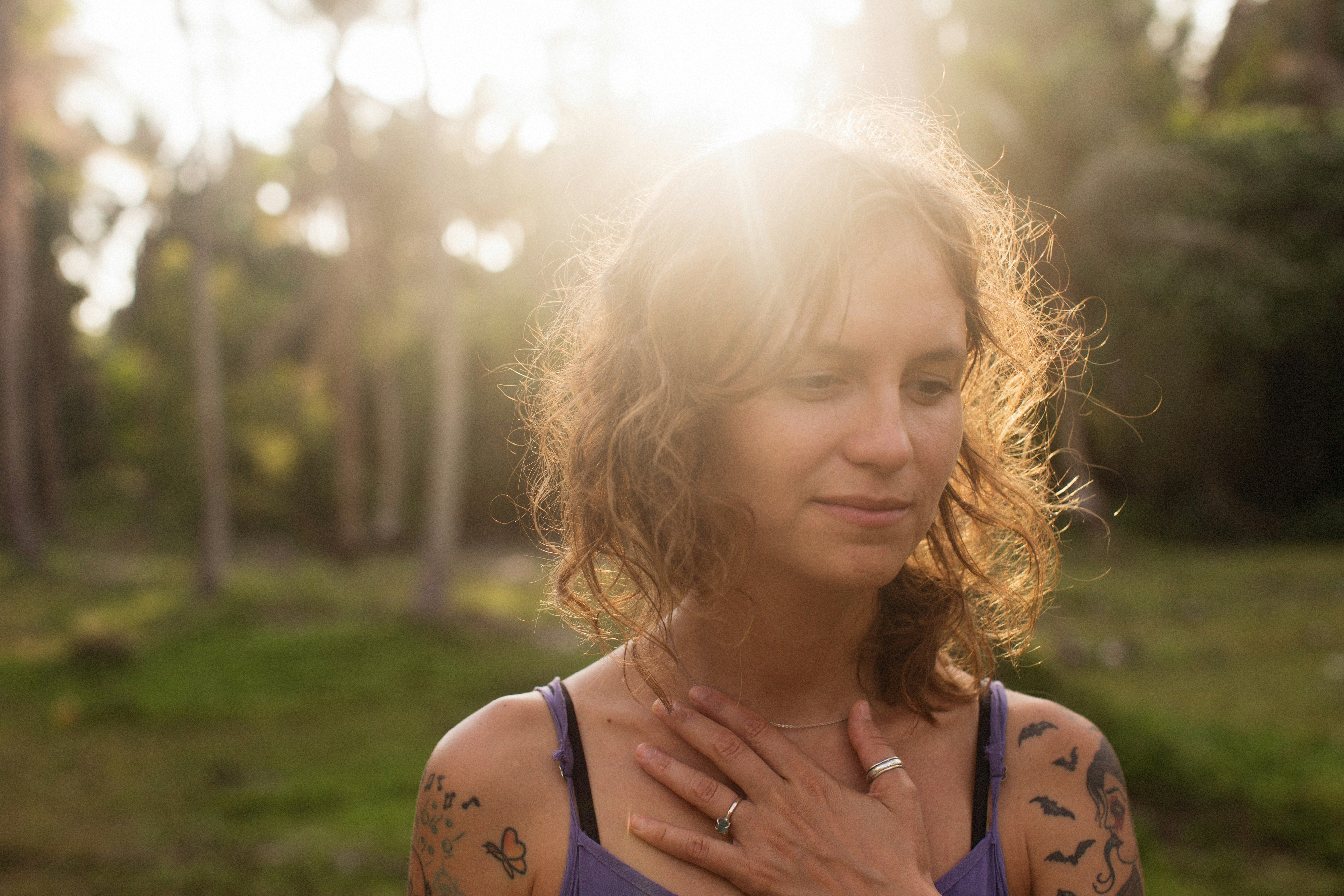 Woman in soft natural light, reflecting calm and nervous system relaxation