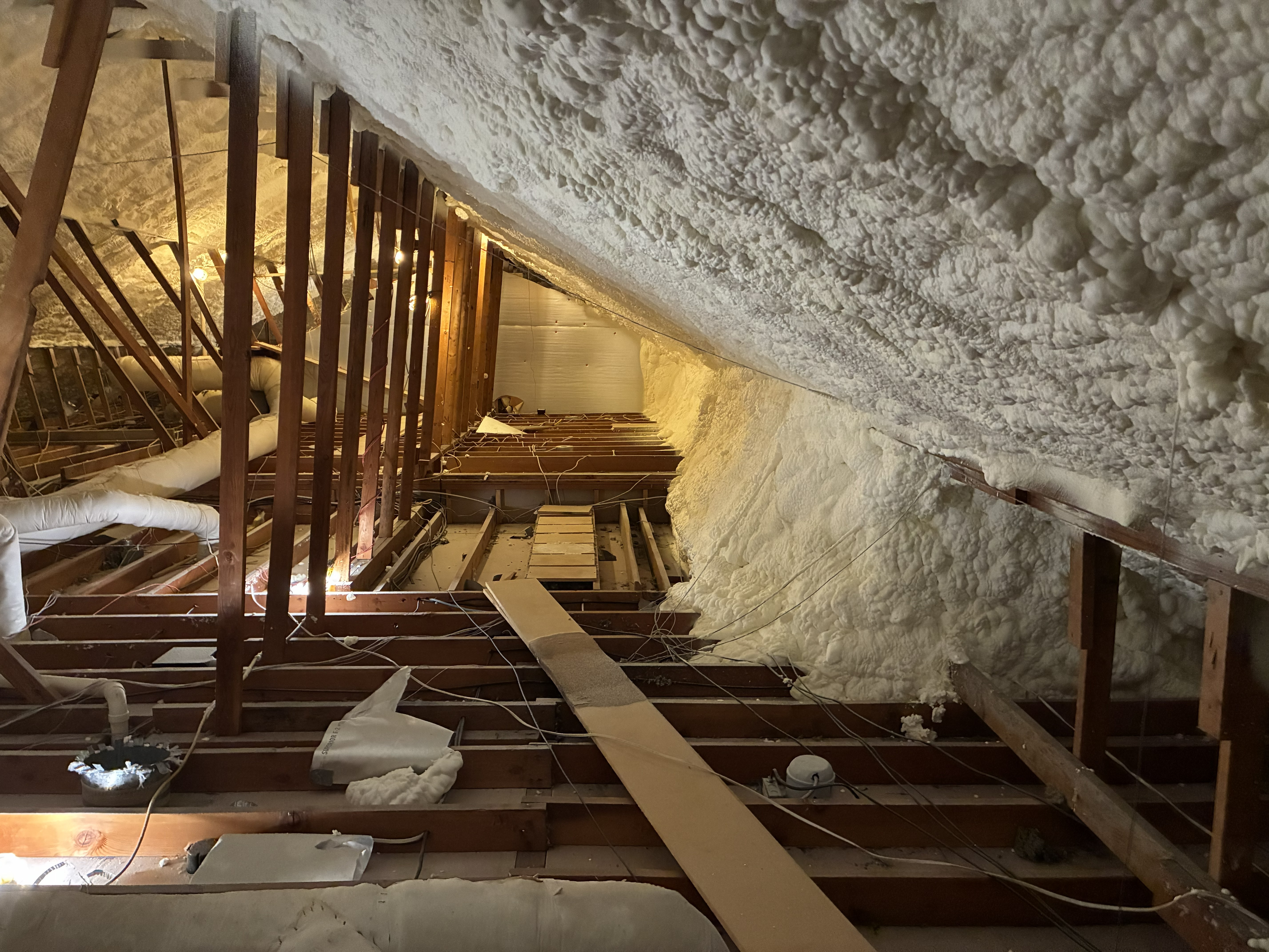 Books are stacked on a windowsill.