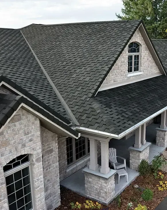 a newly installed shingle roofing of a house