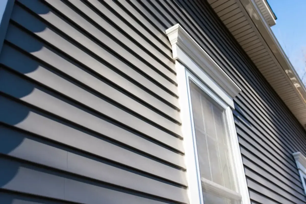 a vinyl siding of a house with white windows