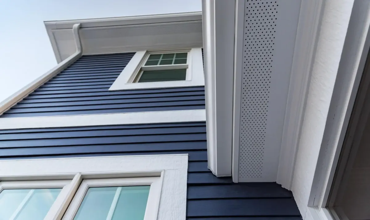 a vinyl siding of a house with white windows