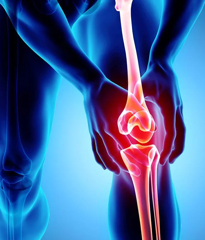 a small child's foot with a red object in the background