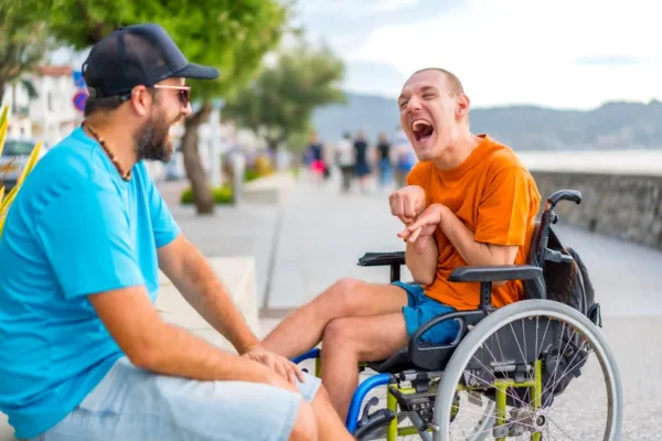 A man looking after a person with disability
