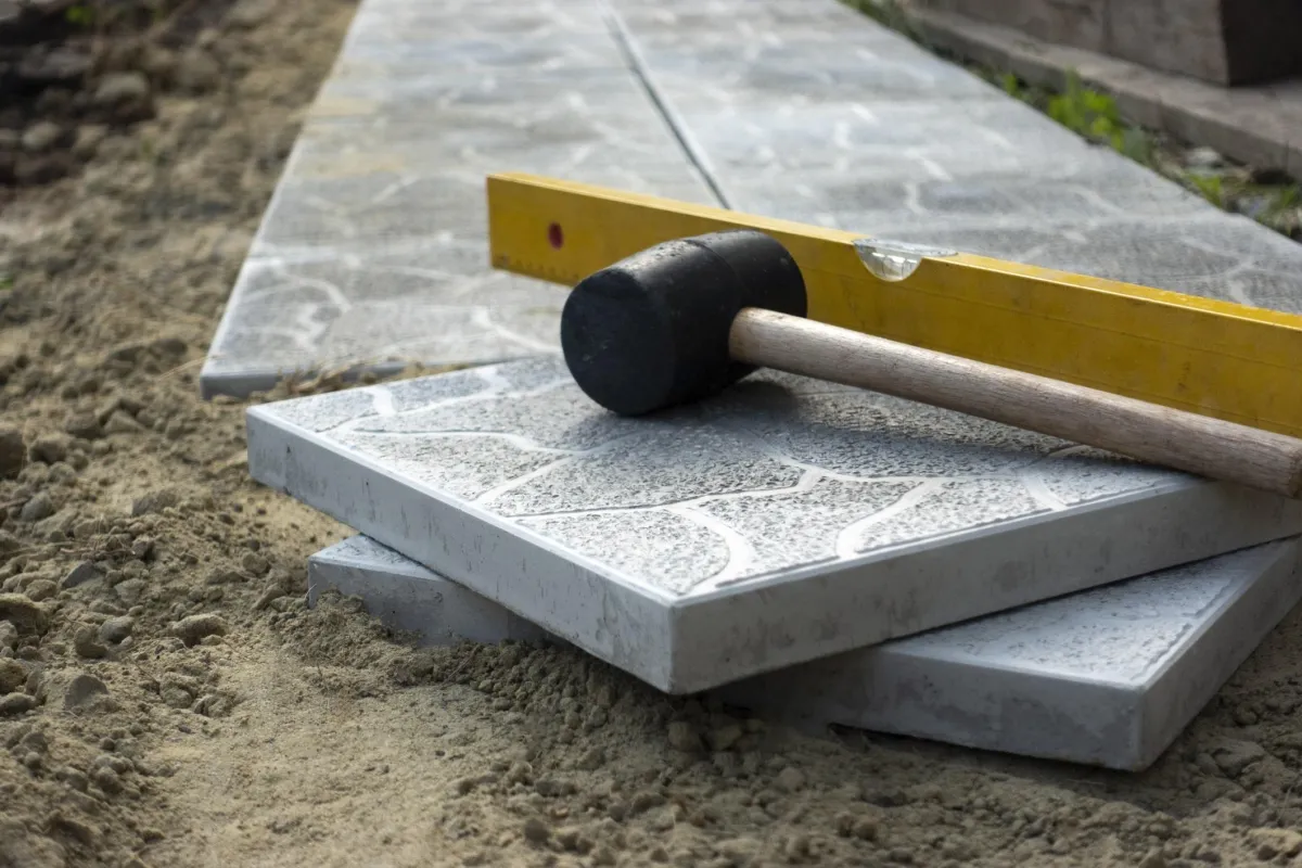 Gray concrete slabs in house courtyard on sand foundation base