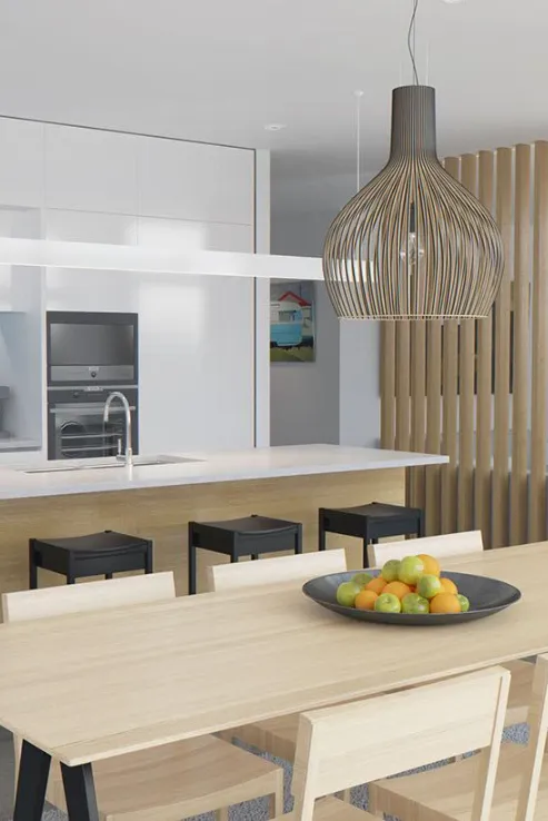 Modern kitchen with a wooden dining set, island bench, and pendant lighting, reflecting a clean and functional remodel.
