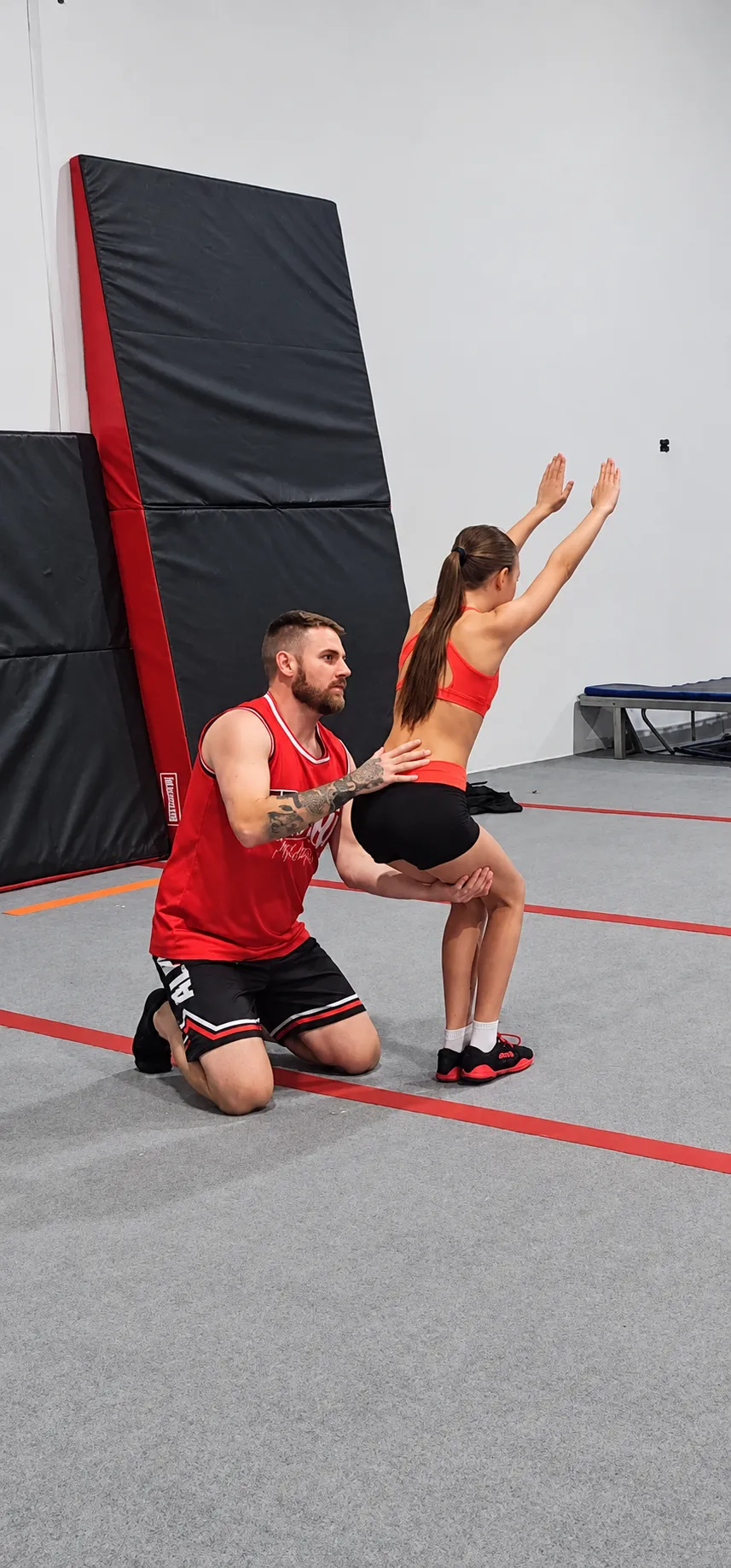 Coach Matt mentoring a competitive cheer athlete during tumbling mindset training