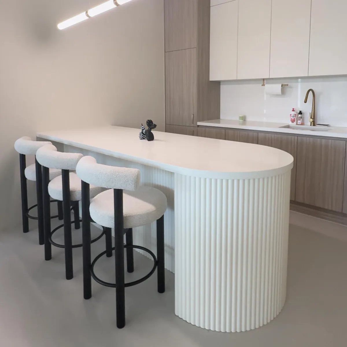 Modern bathroom vanity with marble tiles and round mirror