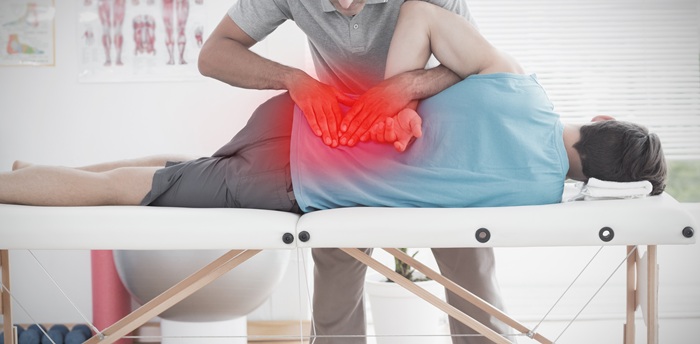 back pain chiropractor with patient 