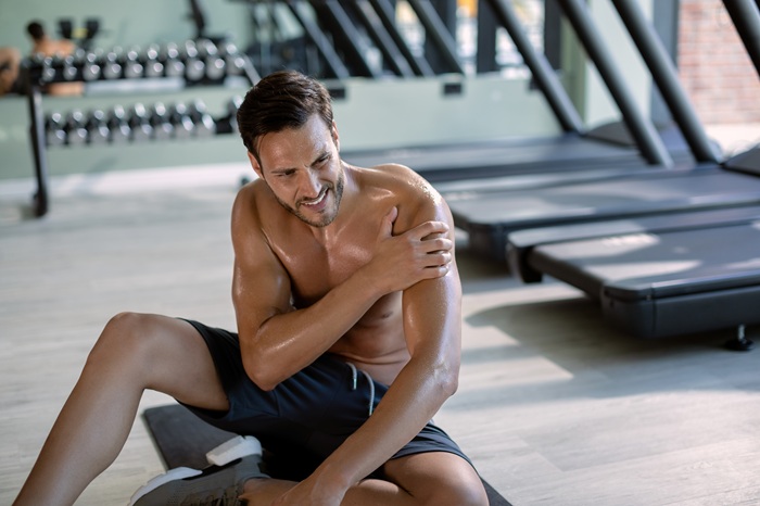 young man at the gym suffering from sport injury