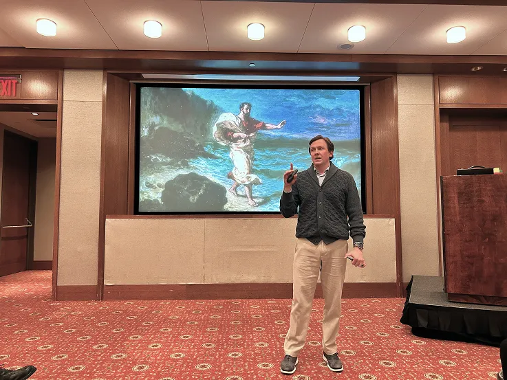 Speaker presenting in front of a large audience