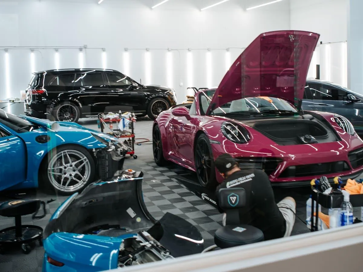 High Gloss protective film installation on a pink and blue Porsche