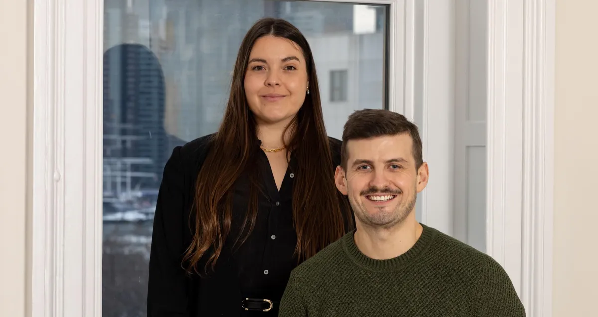 Natalia Harvey standing beside Albert Rossmeier, PhD, in an indoor R&H Advisory Team portrait