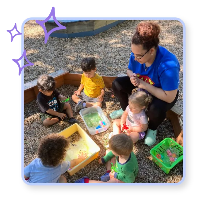 Young children exploring sensory play outdoors with a teacher at Blossoming Humans Spanish immersion preschool in Austin, Texas.
