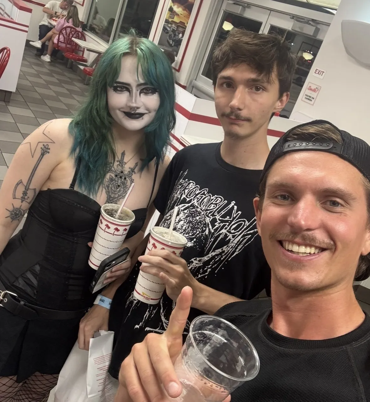 John Hinerman with two young people at a restaurant
