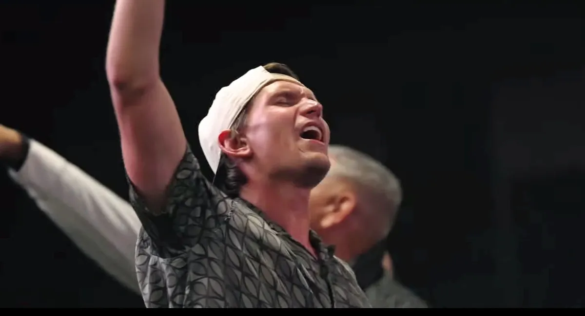 John worshiping with hands raised