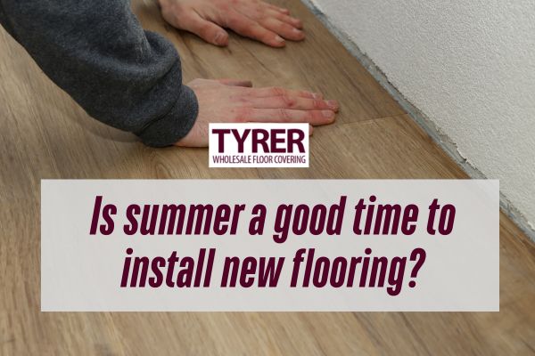man holding the flooring with both hands with a caption Is summer a good time to install new flooring