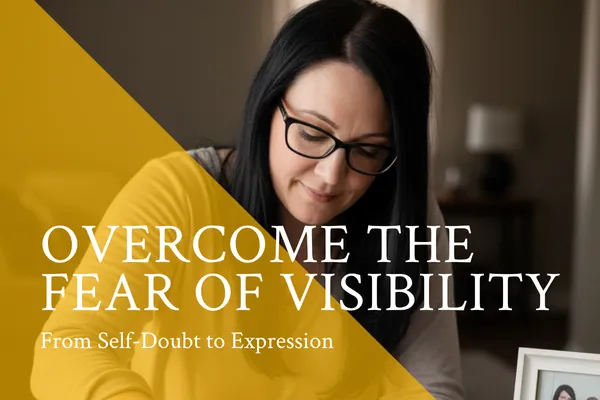Woman with long dark hair and glasses writing in quiet reflection, with the text “Overcome the Fear of Visibility: From Self-Doubt to Expression.”