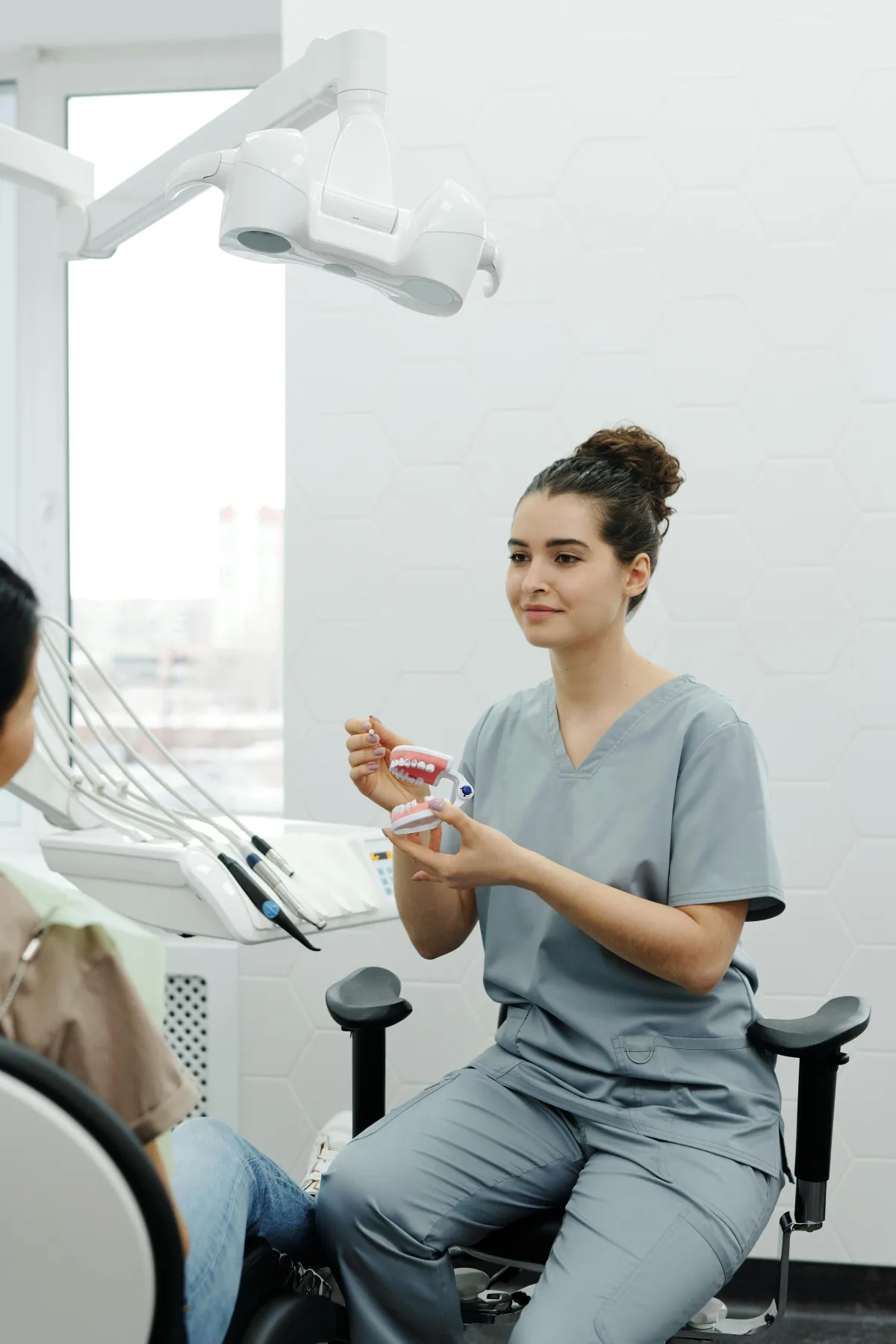 Woman dentist explaining to patient
