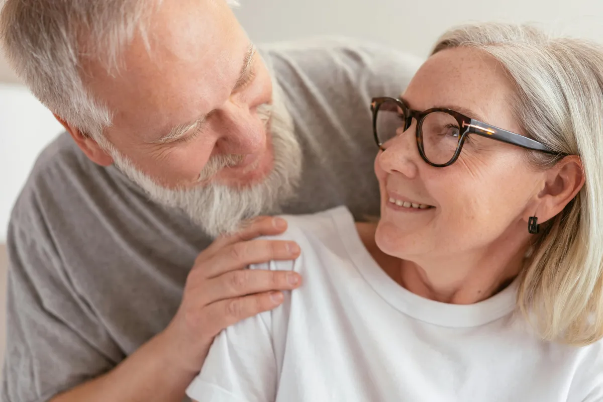 Middle-aged couple smiling at each other
