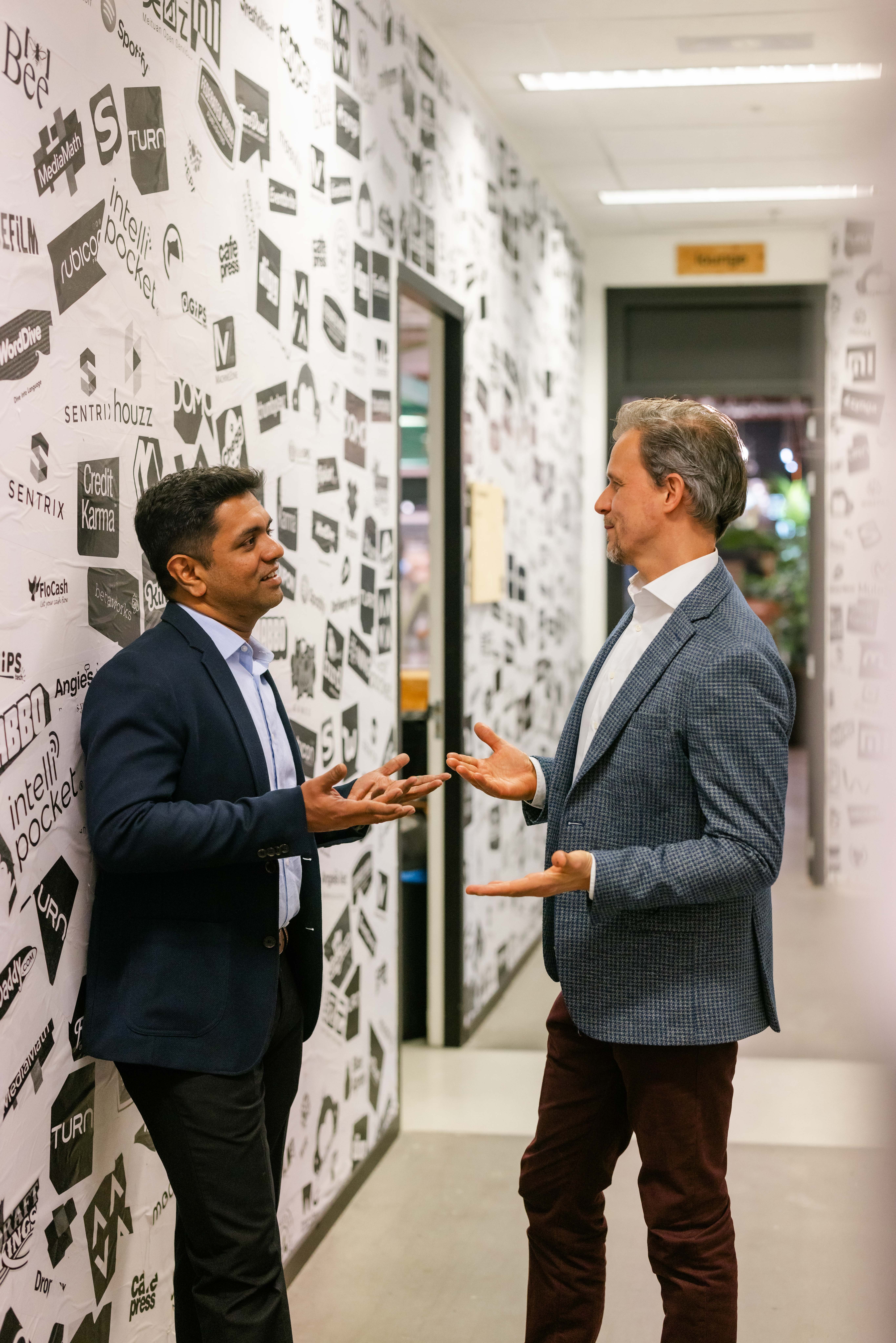 Customer success photograph showing a mid-size retailer analytics team reviewing dashboards in a modern meeting room.