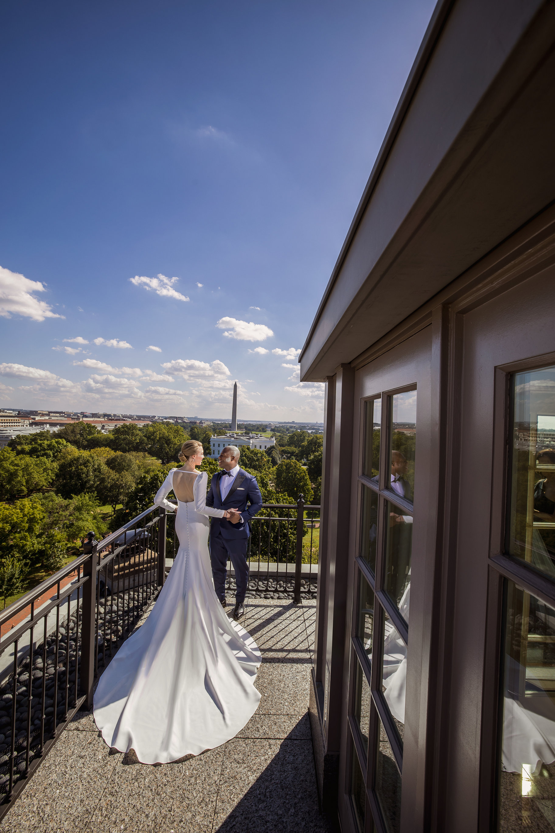 Bride and groom on a terrace overlooking the Washington Monument