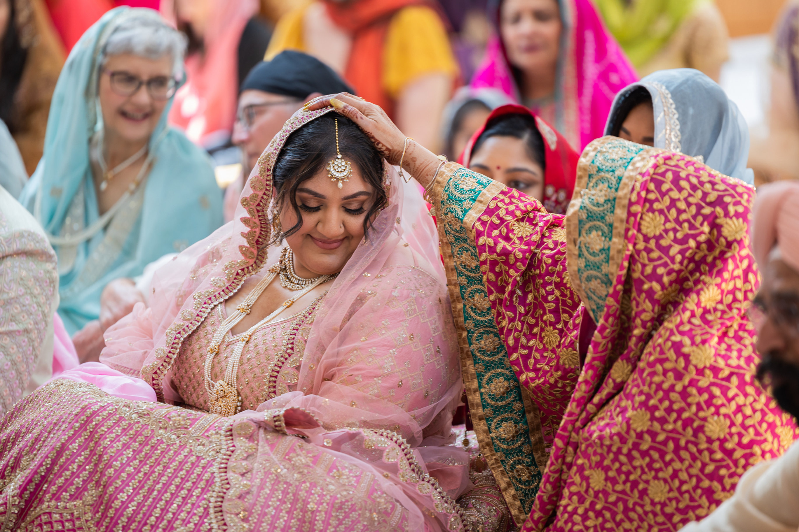 Bride surrounded by family during a South Asian wedding ceremony in Washington D.C.