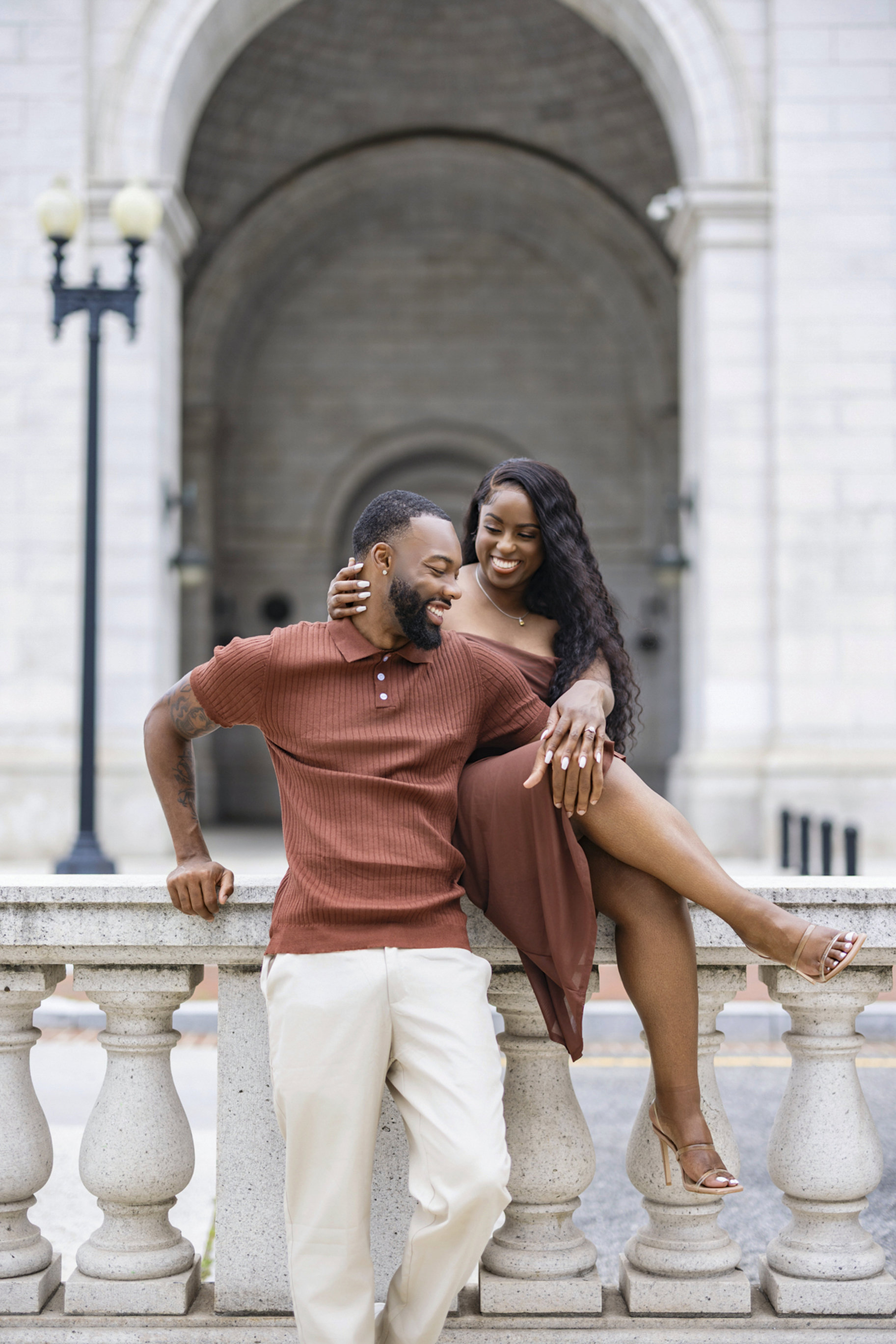 Engaged couple laughing together outside Union Station in Washington D.C.