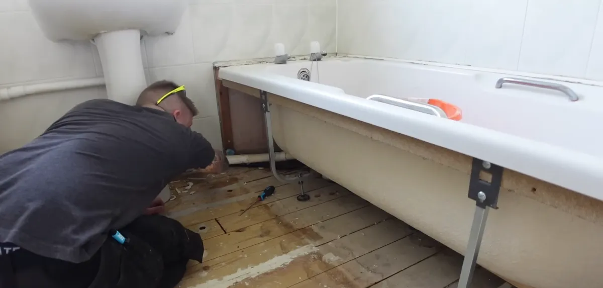 bathroom renovator replacing pipes for bathtub